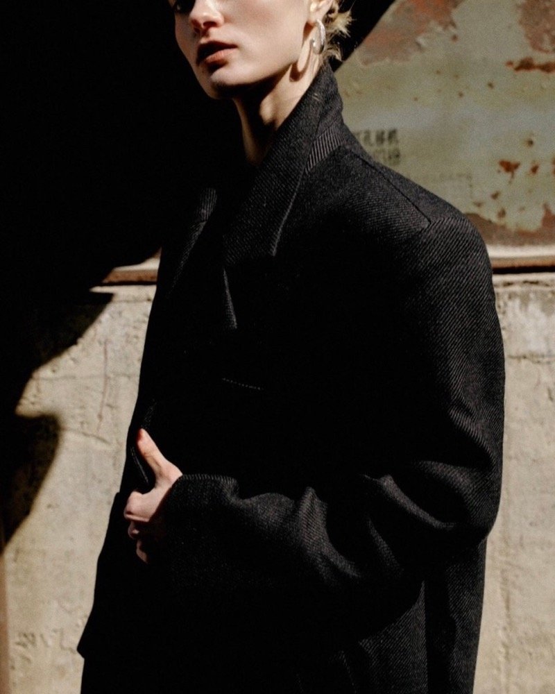 Woman wearing a sculptural black coat